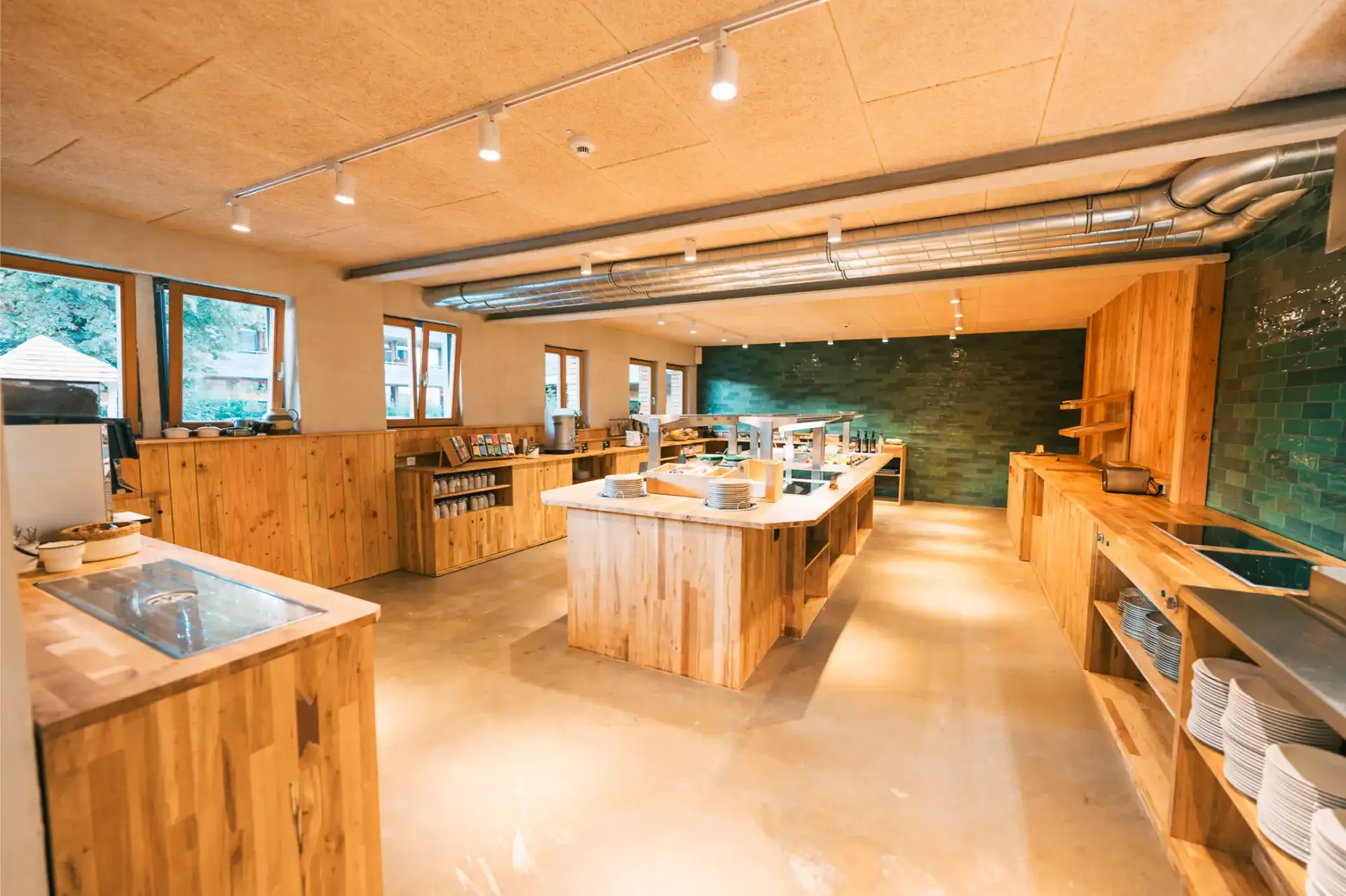 Table en bois et banc dans l’espace restaurant du Gut Hügle